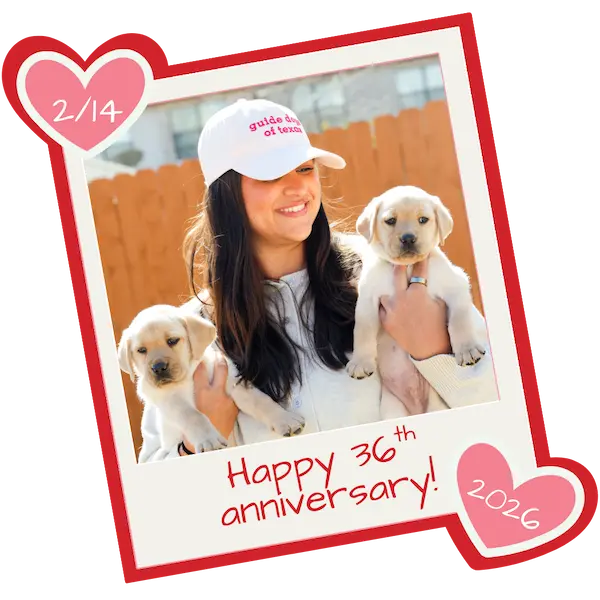 Briana holding 2 yellow lab puppies while wearing the pink Guide Dogs of Texas hat